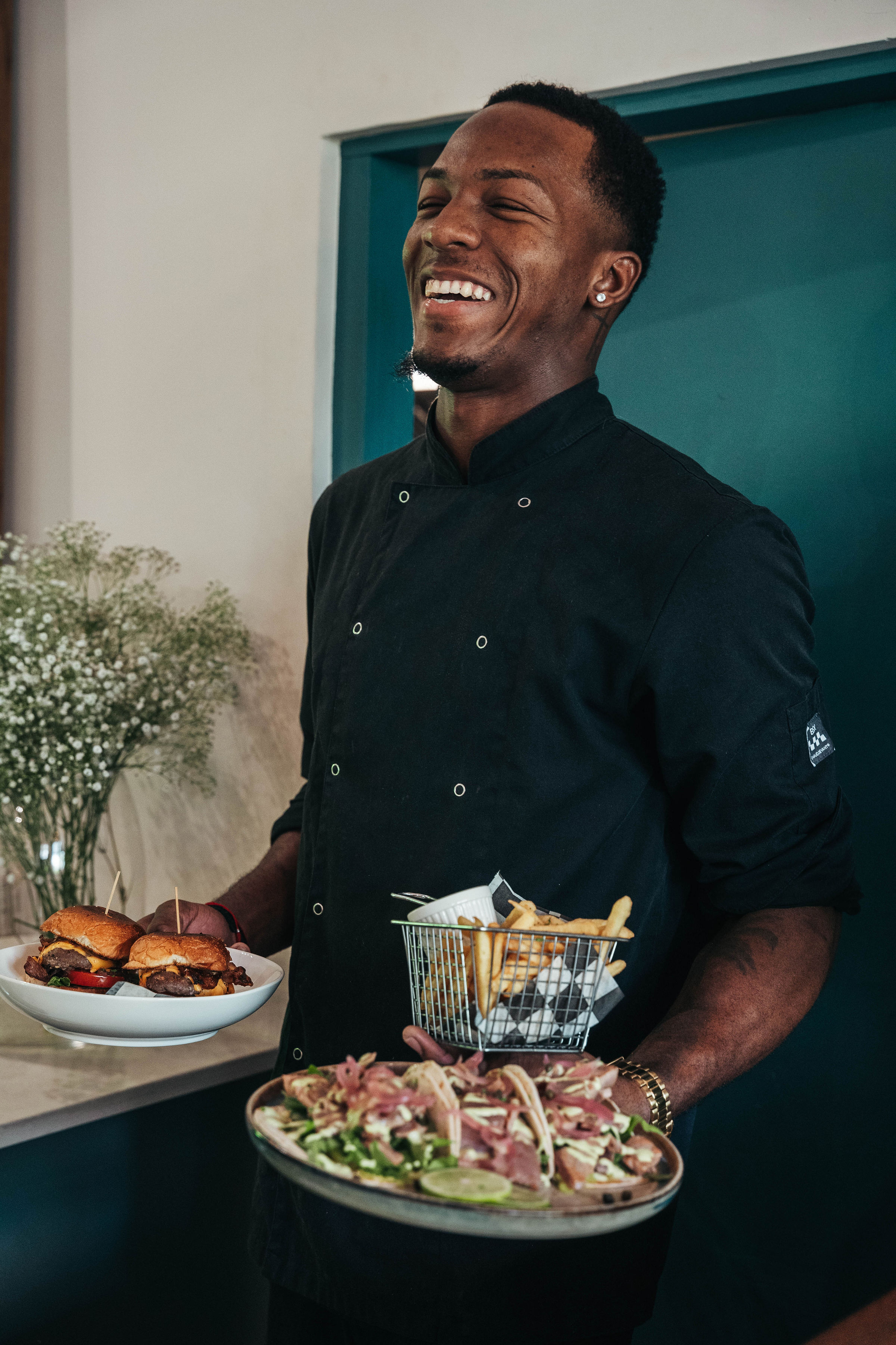 A James cook bringing plates to the table